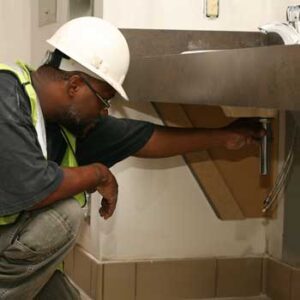 White hard hat wearing plumber