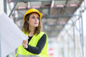 woman construction worker reading plans